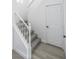 Elegant staircase with white railings and grey carpeting at 7769 Somerhill Point Way, Las Vegas, NV 89139