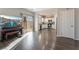 Living room with hardwood floors, piano, and kitchen view at 8132 Celina Hills St, Las Vegas, NV 89131