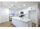 Modern kitchen with white cabinets and a large marble island at 9401 Canyon Shadows Ln, Las Vegas, NV 89117