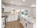 Modern white kitchen with island, stainless steel appliances, and light wood floors at 1000 Macfarlane St, Las Vegas, NV 89101