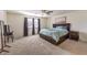 Bright bedroom with large bed, window, and mirror at 10421 Mount Washington Ave, Las Vegas, NV 89166