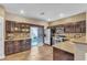 Modern kitchen with dark wood cabinets and stainless steel appliances at 1321 Robbers Roost Ave, Henderson, NV 89012