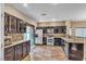 Spacious kitchen featuring dark wood cabinets, stainless steel appliances, and tile flooring at 1321 Robbers Roost Ave, Henderson, NV 89012