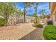 Landscaped backyard with a patio, grill, and gravel areas at 1590 Sabatini Dr, Henderson, NV 89052