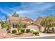 Two-story house with tile roof, landscaping, and attached two-car garage at 1590 Sabatini Dr, Henderson, NV 89052