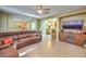 Spacious living room featuring a leather sectional sofa and a large flat-screen TV at 1590 Sabatini Dr, Henderson, NV 89052