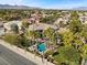 High-angle view of a home with a pool, spa, water slide, and surrounding trees at 2110 Strada Mia Ct, Las Vegas, NV 89117