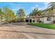 Spacious driveway with basketball court, lush landscaping, and a three-car garage at 2110 Strada Mia Ct, Las Vegas, NV 89117