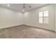 Spacious bedroom with ceiling fan and large window with shutters at 2325 Janesville Ln, Henderson, NV 89044