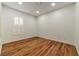 Simple bedroom with hardwood floors and a large window at 2325 Janesville Ln, Henderson, NV 89044