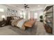 Virtually staged main bedroom with a king-size bed and built-in shelving at 2325 Janesville Ln, Henderson, NV 89044