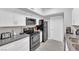 Modern kitchen with white cabinets, black appliances, and granite counters at 2615 W Gary Ave # 1019, Las Vegas, NV 89123