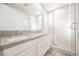 Modern bathroom with double vanity, gray countertop, and large shower at 2824 Evening Rock St, Las Vegas, NV 89135