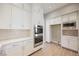 Modern kitchen with white cabinets, stainless steel appliances, and built-in microwave at 2824 Evening Rock St, Las Vegas, NV 89135