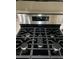 Close-up view of a stainless steel gas cooktop at 3023 Sunset Harbor Ct, North Las Vegas, NV 89031