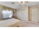 Bedroom with carpeted floors, large window with curtains, built-in closet, and ceiling fan at 3216 Burton Ave, Las Vegas, NV 89102