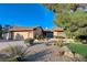 Single-story home with desert landscaping, attached two-car garage, and teal front door at 3216 Burton Ave, Las Vegas, NV 89102