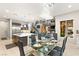 Open concept dining area with glass table and modern chandelier at 4024 Desert Trace Ct, Las Vegas, NV 89129