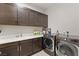 Bright laundry room with washer, dryer, and ample cabinet space at 4024 Desert Trace Ct, Las Vegas, NV 89129