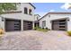 Two-car garage with modern dark brown doors and glass accents at 4120 San Capri Way, Las Vegas, NV 89141