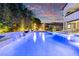 Luxury pool and spa with fire pit and waterfall features at dusk at 4120 San Capri Way, Las Vegas, NV 89141