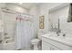 Bathroom boasts white vanity, floral shower curtain, and marble-look tile at 5079 E Long Leaf Ct, Pahrump, NV 89061