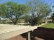 Partial view of backyard with pergola and grassy area at 5087 Penryn Ct, Las Vegas, NV 89139