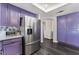 Stainless steel refrigerator and purple cabinets in kitchen at 5216 Velazco Ln, Las Vegas, NV 89130