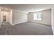 Spacious bedroom with gray carpeting and large window at 7533 Cooper Cove Dr # Lot 13, North Las Vegas, NV 89084