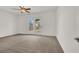 Bright bedroom with plush carpeting and access to the backyard at 7738 Comanche Canyon Ave, Las Vegas, NV 89113