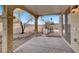 Covered patio with flagstone flooring and access to backyard at 7738 Comanche Canyon Ave, Las Vegas, NV 89113