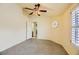 A bright bedroom featuring tile flooring and a ceiling fan, with a view of the bathroom at 7900 Mt Shasta Cir, Las Vegas, NV 89145