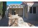 White pergola covers this patio, which has a sliding glass door leading inside at 8560 Desert Holly Dr, Las Vegas, NV 89134