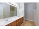 Double vanity bathroom with wood cabinets and a bathtub at 9330 W Maule Ave # 208, Las Vegas, NV 89148