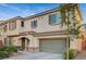 Two-story house with a neutral color scheme and a two-car garage at 9715 Aleutian St, Las Vegas, NV 89178