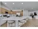 Modern kitchen with white quartz countertops, stainless steel appliances, and light wood cabinets at 10389 Felice Ave, Las Vegas, NV 89135