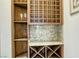 Custom wine cellar with wooden racking and granite countertop at 1529 Villa Rica Dr, Henderson, NV 89052