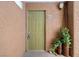 Condo entrance with a green door, potted plants, and address number 204 at 2110 Sealion Dr # 204, Las Vegas, NV 89128