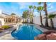 Stunning pool with a large patio and mature palm trees at 2111 Alberti Ct, Las Vegas, NV 89117