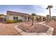 Backyard with a covered patio, palm trees, decorative walkway, and desert landscaping at 2129 Colvin Run Dr, Henderson, NV 89052