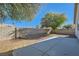 Landscaped backyard with a concrete patio and block wall at 2432 Country Valley Ct, North Las Vegas, NV 89030