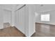 Hallway with sliding closet doors and wood-like flooring at 2672 Rungsted St, Las Vegas, NV 89142