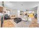 Open concept living room with adjacent kitchen and breakfast bar at 309 Wild Plum Ln, Las Vegas, NV 89107