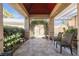 Relaxing covered patio with tile flooring and seating area at 309 Wild Plum Ln, Las Vegas, NV 89107