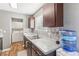 Kitchen with dark cabinets, geometric backsplash, and laundry area at 3400 Landau St, North Las Vegas, NV 89030