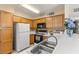 Well-equipped kitchen with white appliances and wood cabinets at 3425 E Russell Rd # 240, Las Vegas, NV 89120