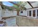 Private backyard with a covered patio, palm tree, and raised garden beds at 3450 Monte Carlo Dr, Las Vegas, NV 89121