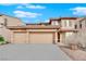 Two-story house with three-car garage and desert landscaping at 4028 Kristina Lynn Ave, North Las Vegas, NV 89081