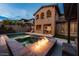 Home's backyard features a pool, spa, and fire pit at 445 Rosina Vista St, Las Vegas, NV 89138