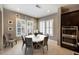 Bright dining area with a round table and chairs, white shutters, and modern lighting at 445 Rosina Vista St, Las Vegas, NV 89138